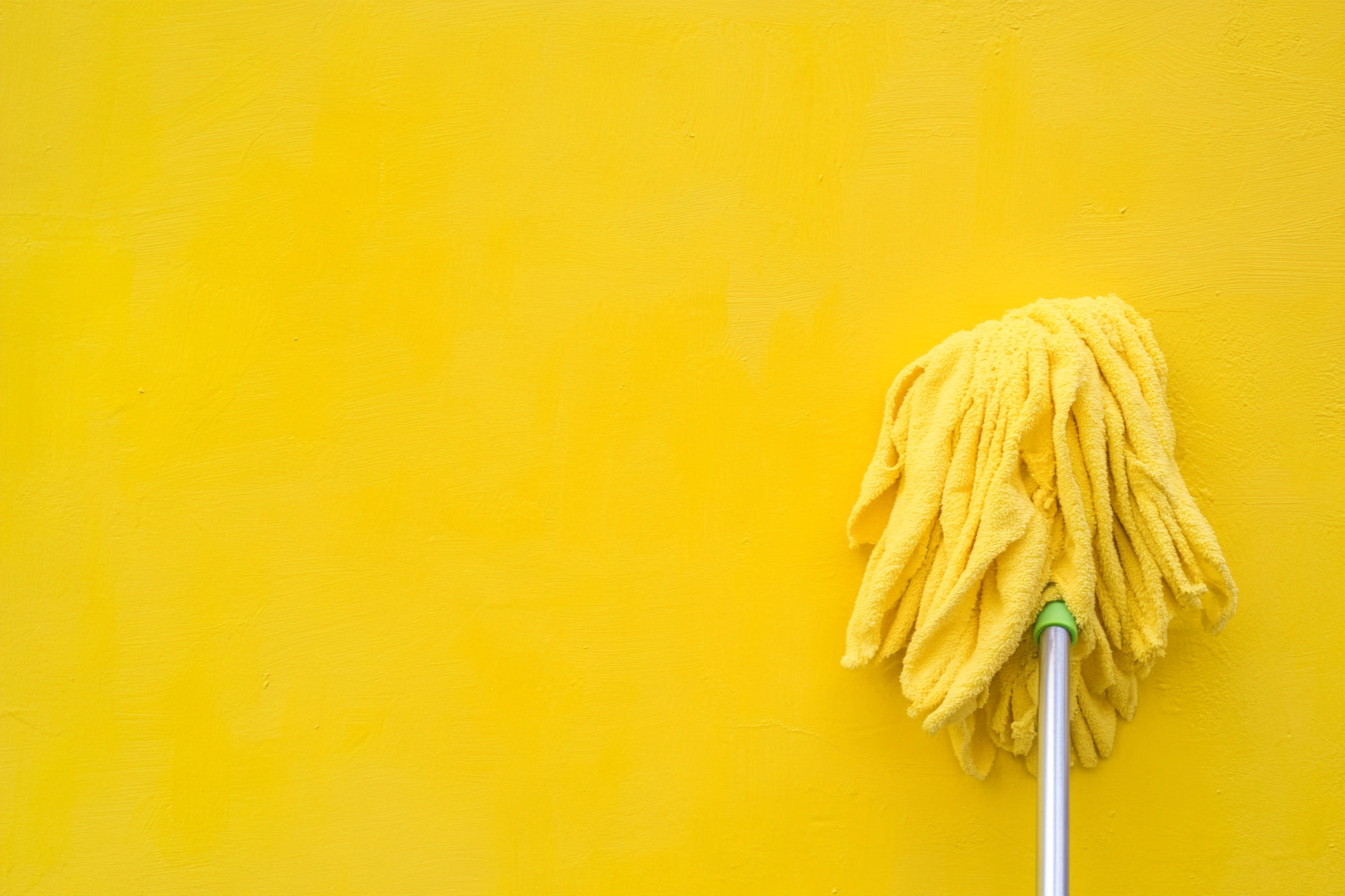 Cleaning walls with a microfiber flat mop and gentle cleaner for a spotless finish.